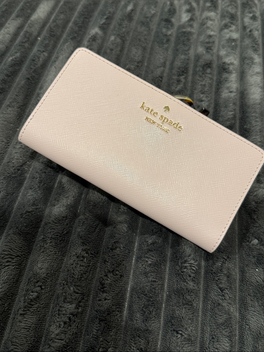 kate spade Madison Large Slim Bifold Wallet features a floral-printed interior